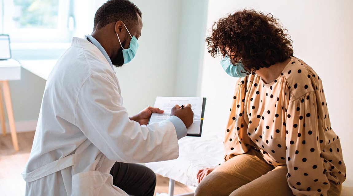 Provider reviewing chart with patient