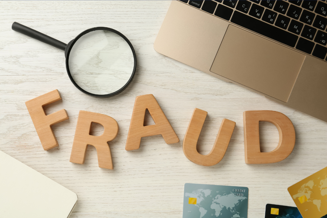 The word Fraud in wood letters